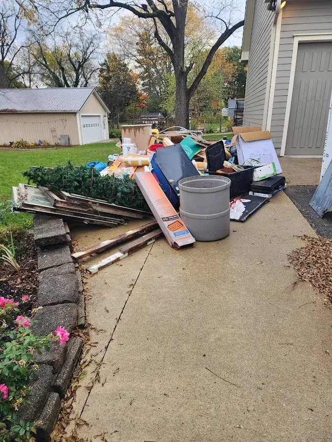 Dumpster being loaded with debris for Estate Cleanout Dumpster Rental in Harrison
